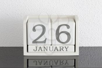 White block calendar present date 26 and month January on white wall background