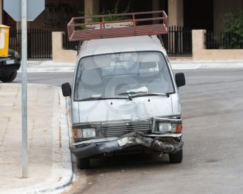 Busted bumper on front end of a modern van - Greece