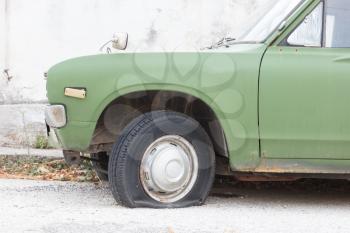 Broken old car at the side of a Greek road - Unrecognisable