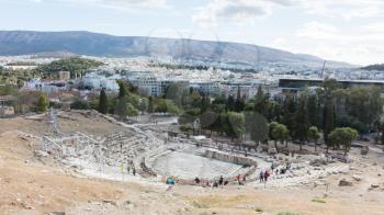 Athens, Greece - October 24, 2017: Panoramic view from the south slope of the Acropolis of Athens with the Theater of Dionysus Eleuthereus in the foreground and the city of Athens in the background.
