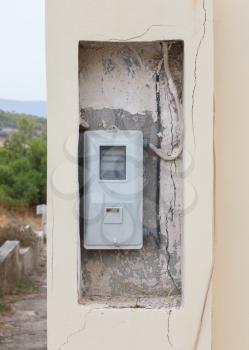 Old electricity meter in a village in Greece