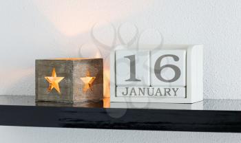 White block calendar present date 16 and month January on white wall background