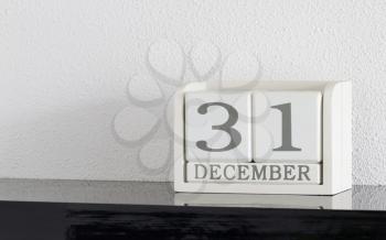 White block calendar present date 31 and month December on white wall background
