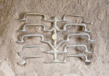 Metal casting - Fresh handles cooling down in the sand - Production in the past