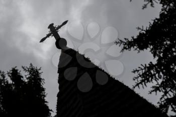 Cross on top of a church - Silhouette with trees