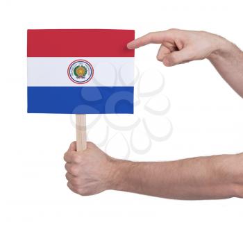 Hand holding small card, isolated on white - Flag of Paraguay