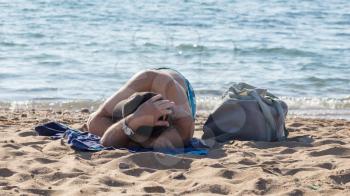 Unrecognisable man relaxing at the beach in Greece