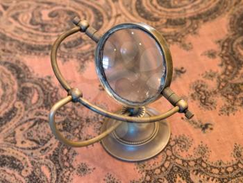 Vintage magnifier loupe  standing on a table  - Selective focus