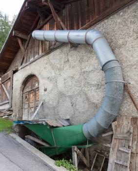 Machine for making hay bales, barn in Austria