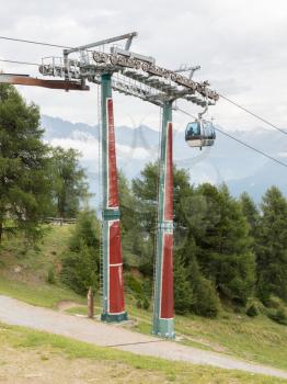 Ski lift chair in the Alps - Unrecognisable people in it - Austria