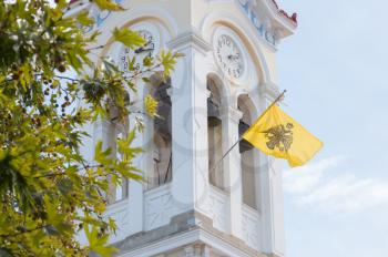 Church in Greece with a waving flag - Local flag of a village