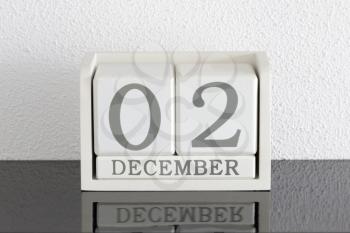 White block calendar present date 3 and month December on white wall background