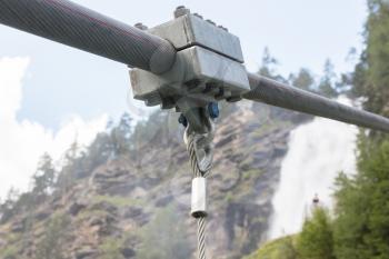 Detail of a hanging metal bridge over a waterfall in the Austrian Alps - Stuibenfall waterfall
