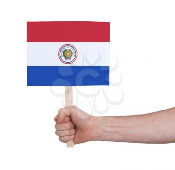 Hand holding small card, isolated on white - Flag of Paraguay