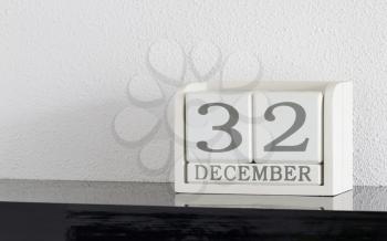 White block calendar present date 32 and month December on white wall background - Extra day