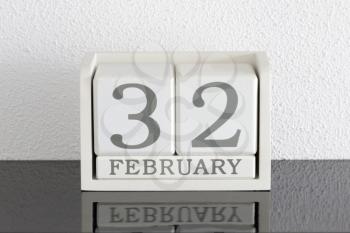 White block calendar present date 32 and month February on white wall background - Extra day