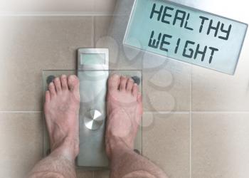 Closeup of man's feet on weight scale - Healthy weight