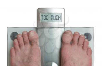 Closeup of man's feet on weight scale - Too much