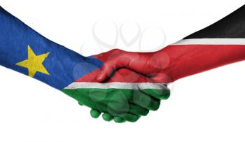 Man and woman shaking hands, wrapped in flag pattern, South Sudan
