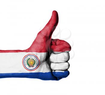 Closeup of male hand showing thumbs up sign, flag of Paraguay