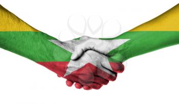 Man and woman shaking hands, wrapped in flag pattern, Myanmar