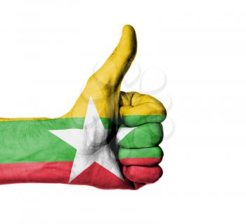 Closeup of male hand showing thumbs up sign, flag of Myanmar