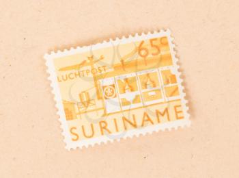 Suriname - CIRCA 1970: A stamp printed in Suriname shows a factory, circa 1970
