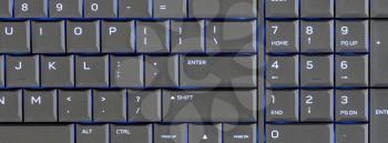 Close up led backlit computer laptop keyboard, blue