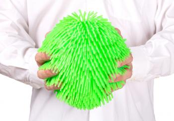Virus like soft rubber ball held by an adult man
