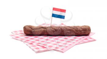 One frikadel on a napkin, a Dutch fast food snack, isolated