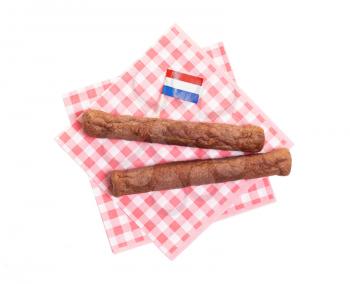 Two frikadellen on a napkin, a Dutch fast food snack, isolated