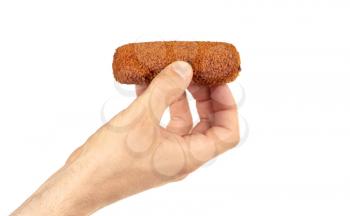 Brown crusty dutch kroket held by an adult man, isolated on a white background