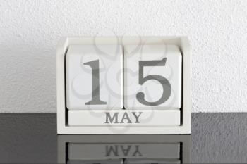 White block calendar present date 15 and month May on white wall background