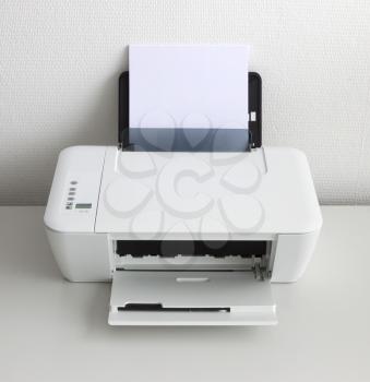 Compact home printer on a white desk