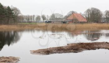 Old dutch farm in the typical dutch wet landscape