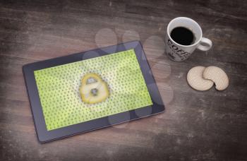 Tablet on a desk, concept of data protection, yellow