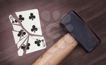 Hammer with a broken card, vintage look, six of clubs