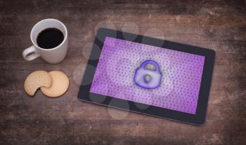 Tablet on a desk, concept of data protection, purple