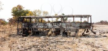 Burned bus at the side of the road, Botswana