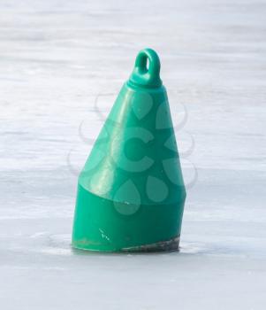 Green buoy in a large pond - Selective focus