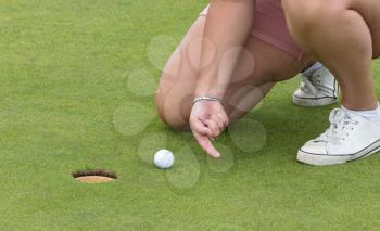 Concept of fun; Playing golf with a finger - Cheating