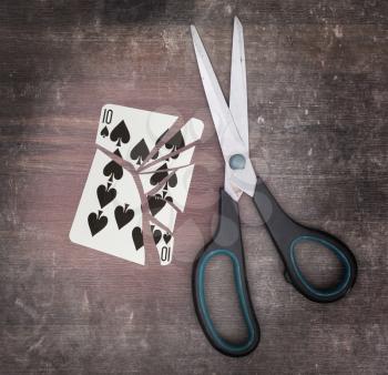 Concept of addiction, card with scissors, ten of spades