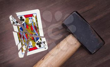 Hammer with a broken card, vintage look, jack of clubs
