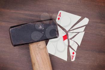 Hammer with a broken card, vintage look, ace of diamonds