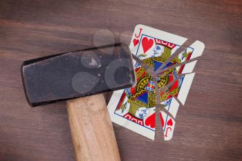 Hammer with a broken card, vintage look, jack of hearts