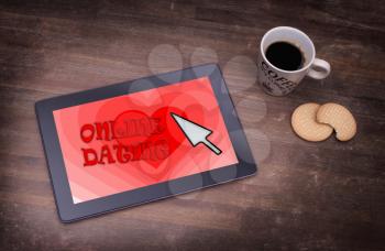 Online dating on a tablet - concept of love, red