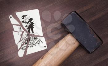 Hammer with a broken card, vintage look, joker