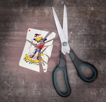 Concept of addiction, card with scissors, joker