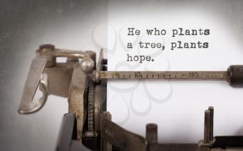 Close-up of a vintage typewriter, old and rusty, he who plants a tree plants a hope