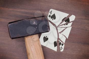 Hammer with a broken card, vintage look, four of spades